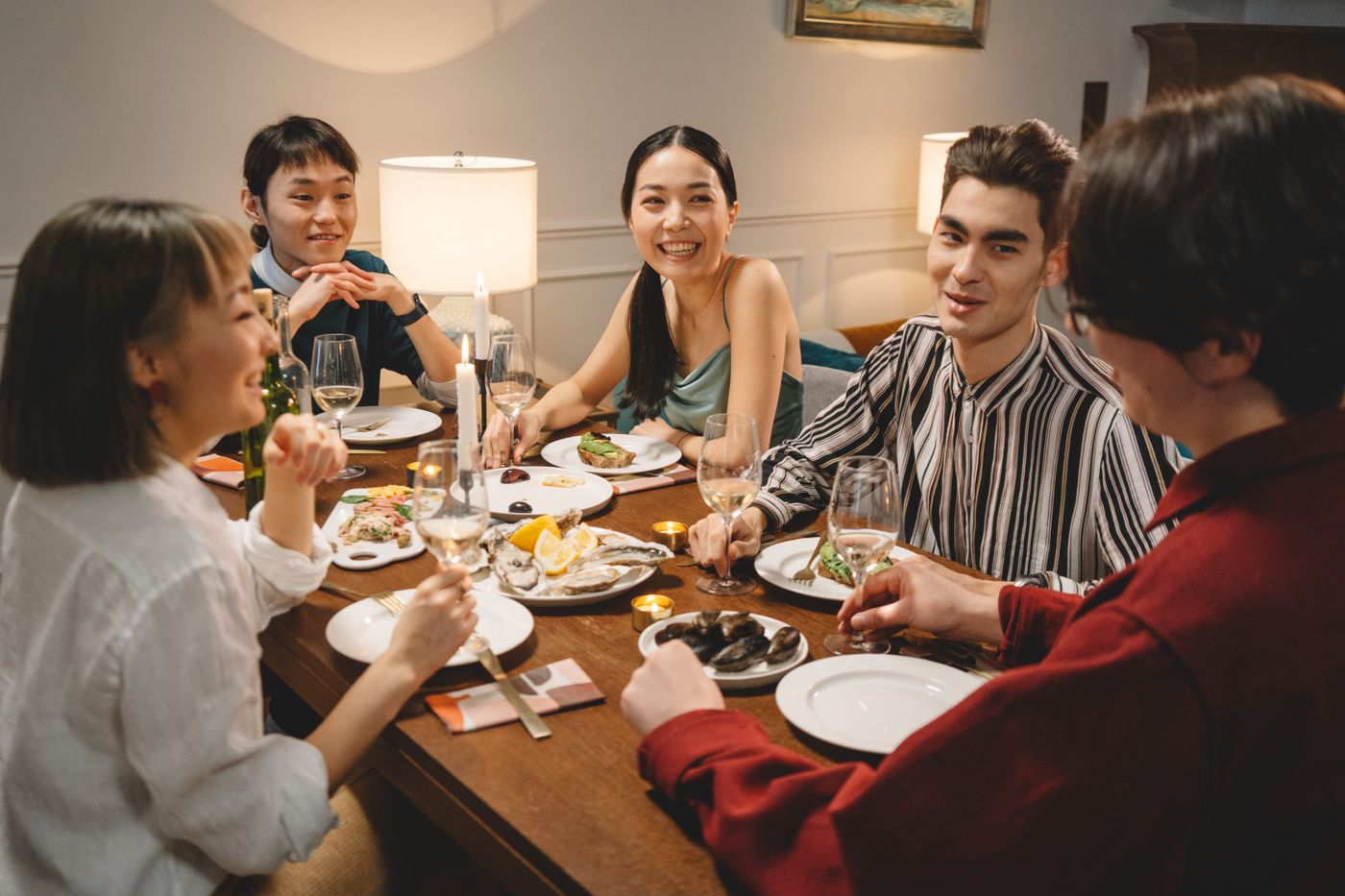 Friends sharing a long dinner together